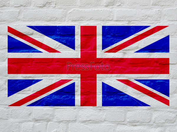 Union Jack national flag of United Kingdom over white bricks wall background