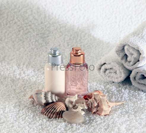 Bottle with massage oil on a background of towel, stock photo