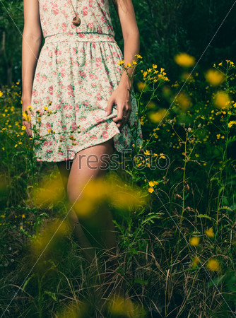 Beautiful woman walks at the country. Casual dress, barefoot.