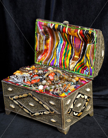 ancient east treasure chest with antique jewelry on black velvet
