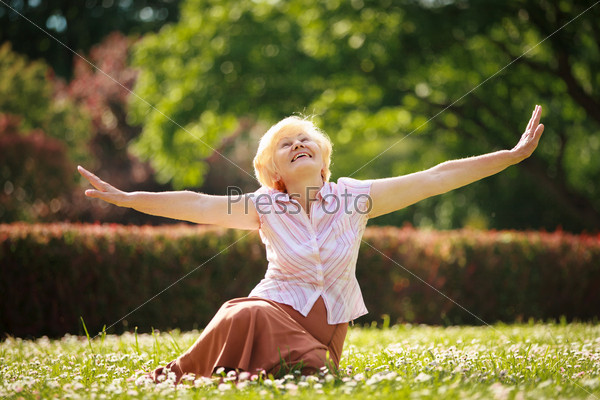 Gladness. Meditation. Mature Pleased Woman Relaxing with Outspread Arms