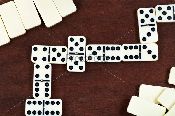 line of play in domino game on wooden table