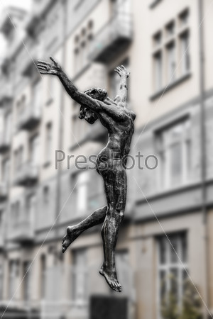 Sculpture of a naked woman on a background of city buildings in black and white. Norway. Bergen