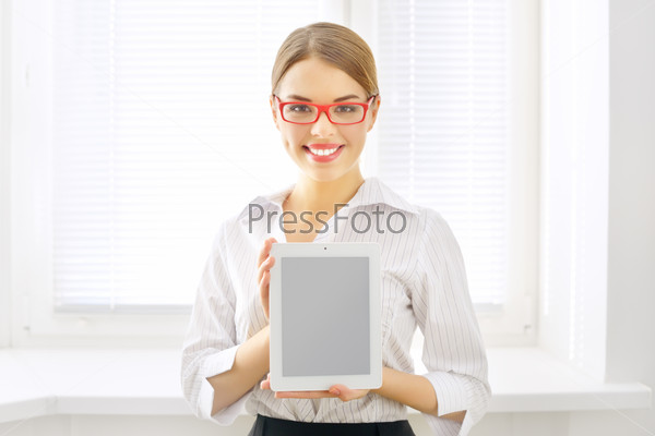 Young business woman with tablet pc on light background
