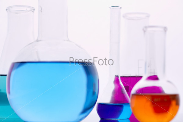 Image of several flasks with multi-color liquids in laboratory, stock photo