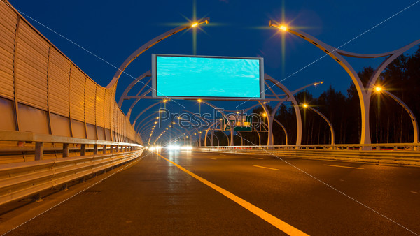Empty big billboard on night highway, stock photo