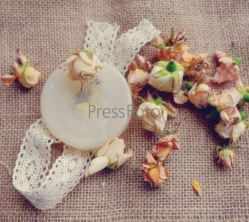 on the fabric dried pink rose buds and soap with ribbon