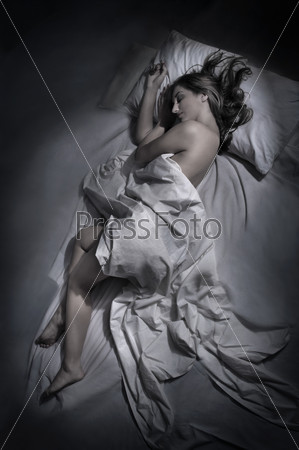 Young woman sleeping at night in bed