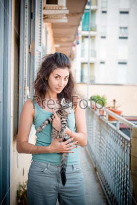 Beautiful woman with cats at home, stock photo