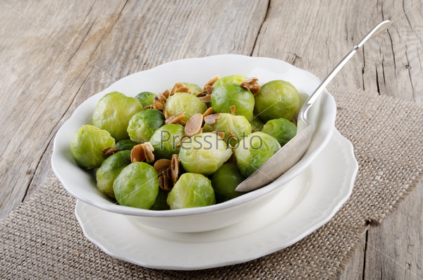 brussel sprouts with roasted almonds in a white bowl