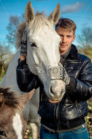Man and horses outdoors