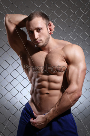 Fitness. Beautiful, strong man and his muscles, stock photo