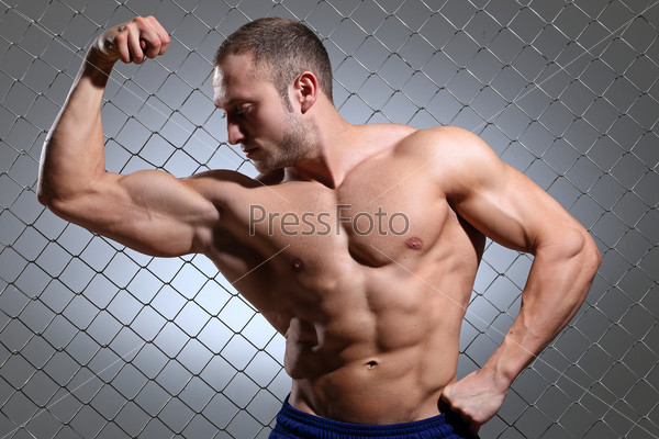 Fitness. Beautiful, strong man and his muscles, stock photo