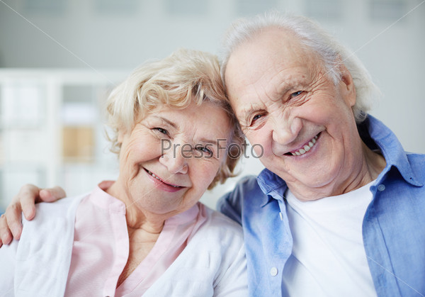 Portrait of senior couple looking at camera with smiles, stock photo