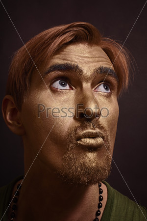 Portrait of young handsome men with gold makeup and red hair