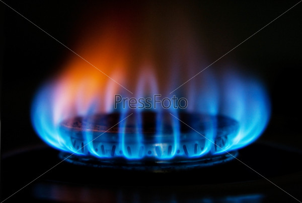 Burning hot blue yellow fire flames from a stove for cooking in a kitchen
