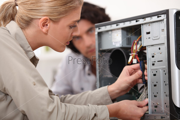 Woman fixing a computer hard drive