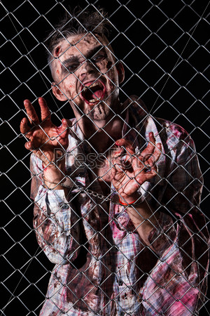 Creepy zombie behind the fence