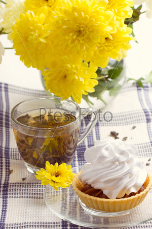 Romantic breakfast. Tea, cake, yellow chrysanthemum