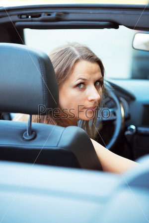Caucasian woman in a cabriolet car