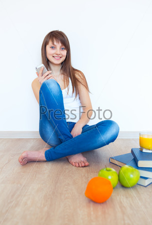 Portrait of a young woman with headphones and green apple listen