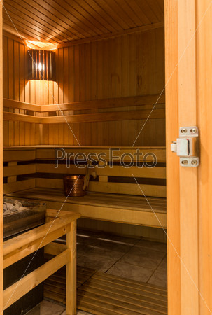 Interior of hot finnish sauna with lights on