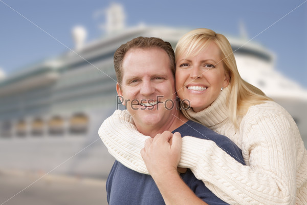 Young Happy Couple Hugging On The Dock In Front of a Cruise Ship.