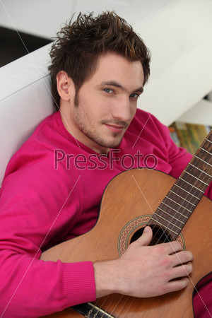 Portrait of a young man playing the guitar