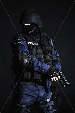 Special weapons and tactics (SWAT) team officer on black
