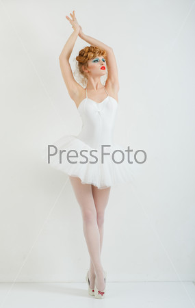 Portrait of a beautiful girl with fashion makeup - red lips, stylish hairstyle. In ballet dress. Tutu.