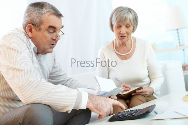Senior Couple Counting Their Expenses