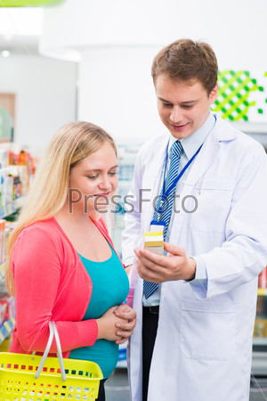 Vertical image of a pharmacist giving practical advice to the client on the foreground