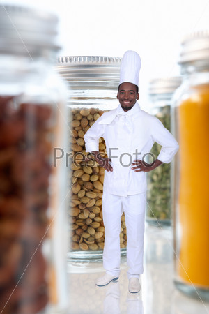 black cook amid giant jars filled with food goods
