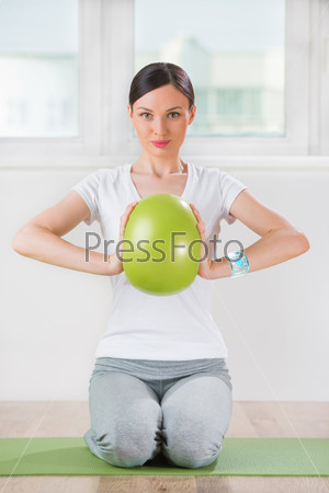 Portrait of modern healthy woman wearing smart watch device with touchscreen doing exercises