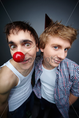 Two guys having fun making faces at camera on fools day