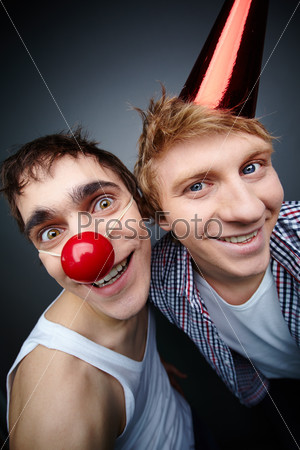 Two guys having fun making faces at camera on fools day