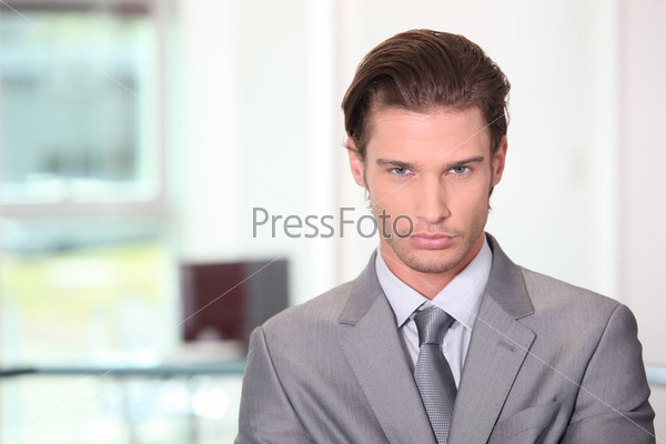 Man dressed in suite with serious expression on face