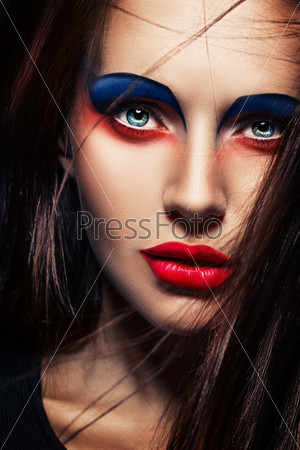 closeup beauty creative red and blue makeup woman face
