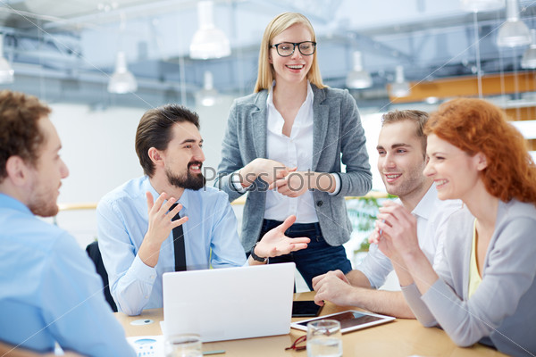 Group of business partners discussing ideas at meeting in office