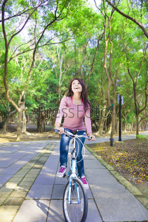 Pretty Woman riding a bike on the forest trail