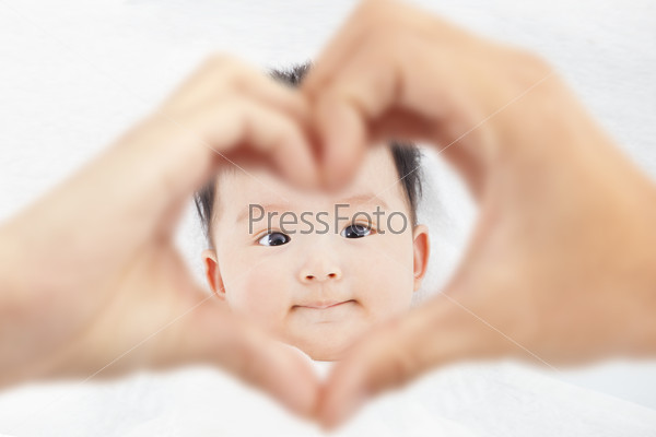 cute and smiling infant  with parents love hands