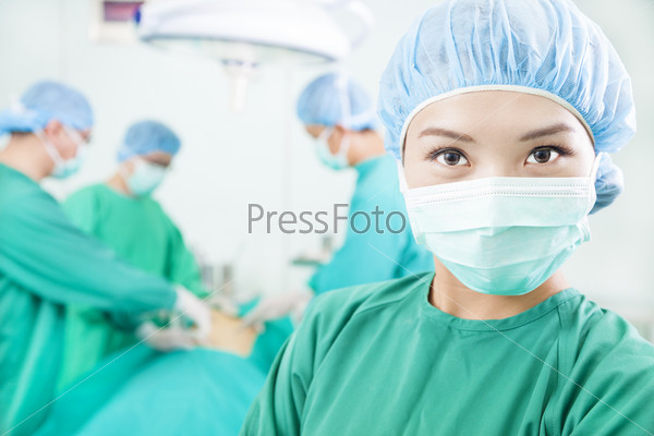 Surgical woman and Surgeons in an operating theater