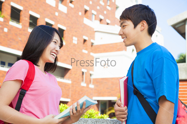 two students or friends are conversation happily