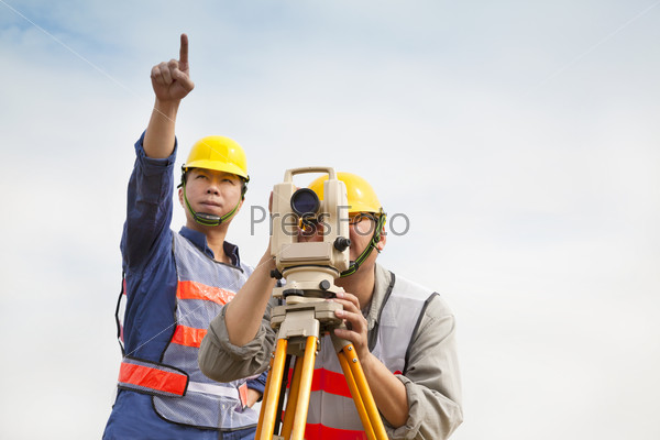 Surveyor engineer making measure with partner