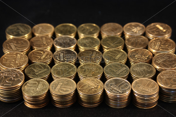 Coins stacked on a black background