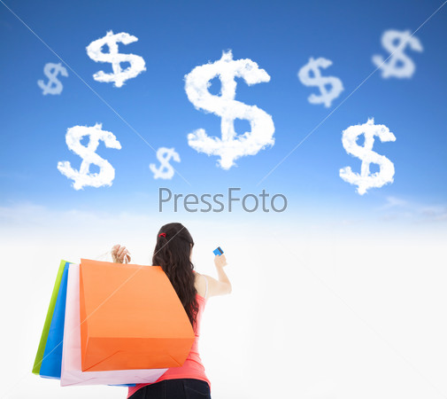 Young woman holding shopping bags and credit card with money clo