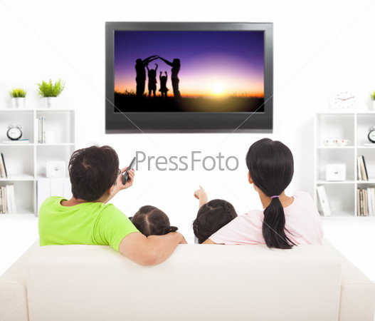 family watching the tv in living room