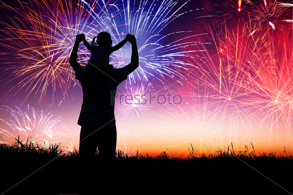 Father With Child Standing On The Hill And Watching The Fireworks