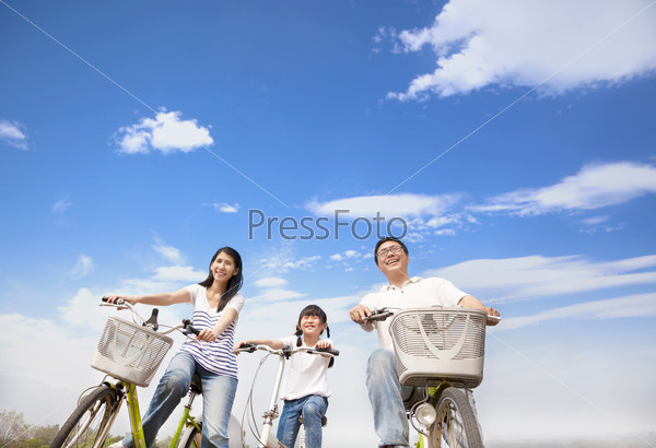 Happy Family Riding Bicycle With Cloud Background