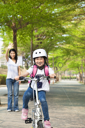 happy little girl riding bicycle go to school